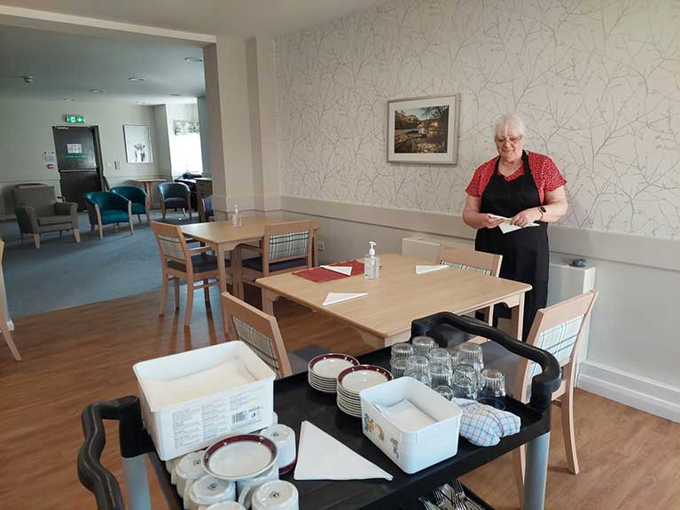 Gail said: “I sanitised and laid tables, helped serve meals to residents, cleared tables and sanitised again. I assisted tidying in the kitchen and made (lots of) coffee and tea for the Chef and his assistant.